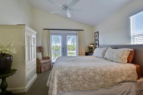 a bedroom with a bed and a window at Coral Villa by AvantStay Close 2 DT Key West Shared Pool Month Long Stays Only in Stock Island