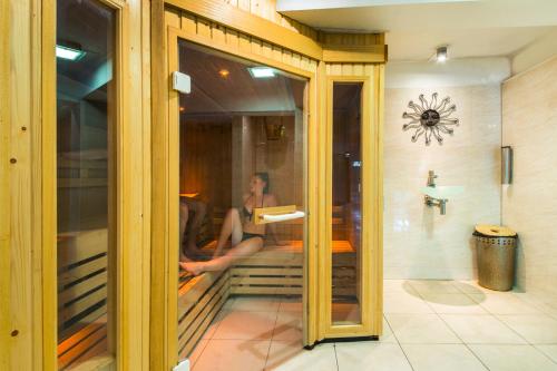 a person sitting in a room through a glass window at Arden Hotel And Leisure Club in Bickenhill