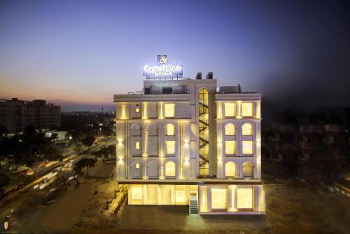 a building with a neon sign on top of it at Cygnett Style Ganga in Jaipur