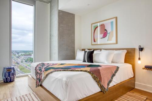 a bedroom with a bed and a large window at Saxon by AvantStay Brand New Condo in Austin w Amazing Amenities in Austin