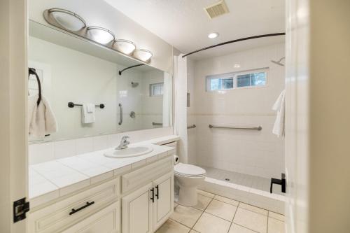 a bathroom with a sink and a toilet and a mirror at Le Grand Bleu by AvantStay Luxury Hilltop Estate in Temecula