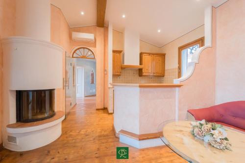 a living room with a fireplace and a table at Villa Tiziana in Casa Morcone