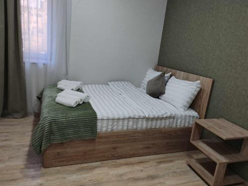 a bedroom with a bed with towels on it at Sun House in Yeghegnadzor