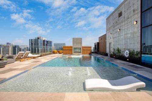 a swimming pool on the roof of a building at Mohawk by AvantStay Brand New Condo Room in Austin w Amazing Amenities in Austin