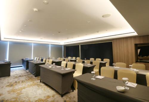 a conference room with tables and chairs in it at Java Paragon Hotel & Residences in Surabaya