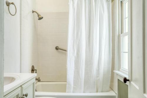 a bathroom with a white shower curtain and a sink at Eloise by AvantStay Historic Upstate Apartment near Hudson River in Saugerties