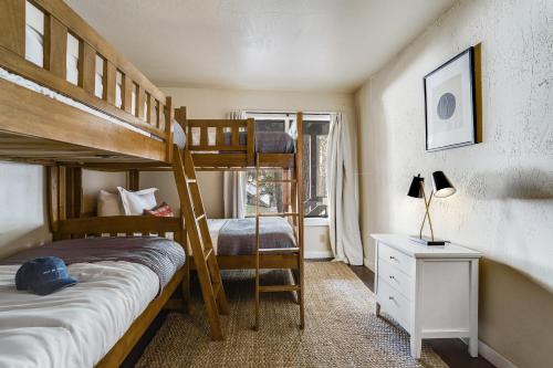 a bedroom with two bunk beds and a desk at Marillac by AvantStay Gorgeous Ski Cabin w Balcony Patio in Olympic Valley