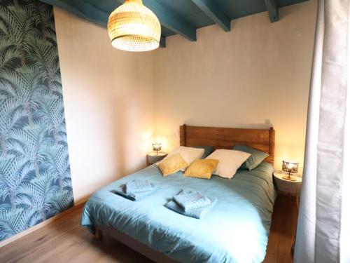 a bedroom with a bed with two pillows on it at Gîte Maurs, 3 pièces, 5 personnes - FR-1-742-135 in Maurs