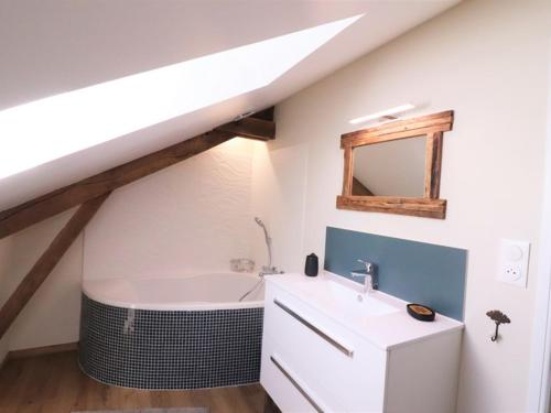 a bathroom with a sink and a bath tub at Gîte Maurs, 3 pièces, 5 personnes - FR-1-742-135 in Maurs