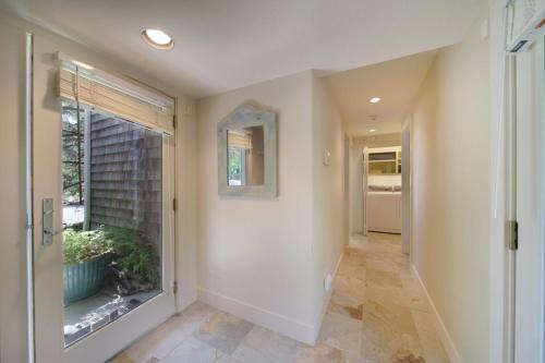 a hallway with a door and a window and a hallway sidx sidx sidx at Chapman Cove by AvantStay Gorgeous Beach Bungalow w Sauna in Cannon Beach