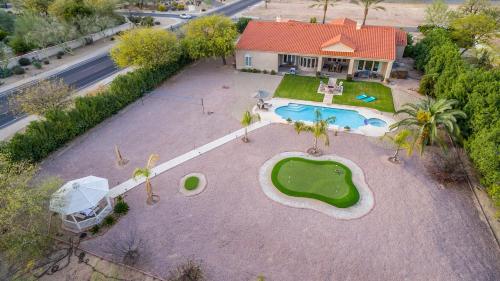 an aerial view of a house with a swimming pool at Paradise Valley by AvantStay Expansive Oasis w Putting Green Pool Mtn Views in Scottsdale