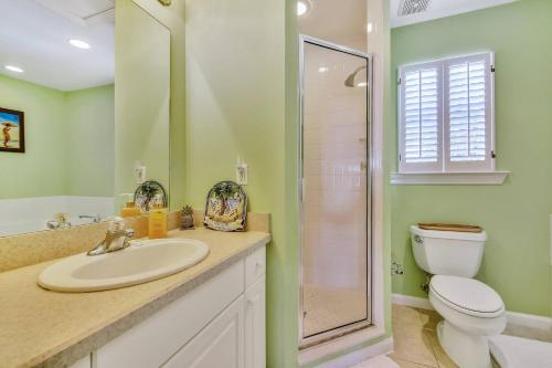 a bathroom with a sink and a toilet at Coral Palm by AvantStay Key West Walkable Gated Community Shared Pool Month Long Stays Only in Stock Island