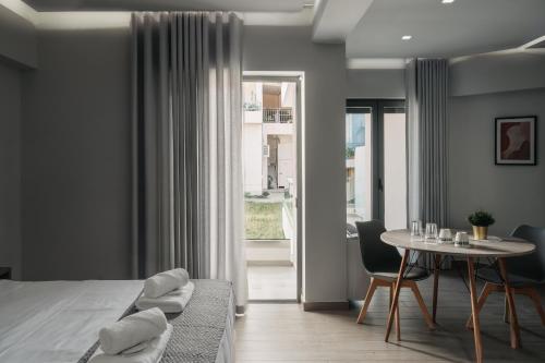 a bedroom with a bed and a table and chairs at Vialmar Premium Apartments in Rio