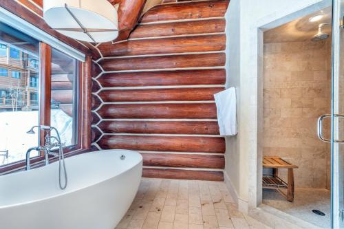 a bathroom with a wooden staircase and a tub at Villas At Tristant 137 by AvantStay Ski In Ski Out Home w Panoramic Views Hot Tub in Telluride