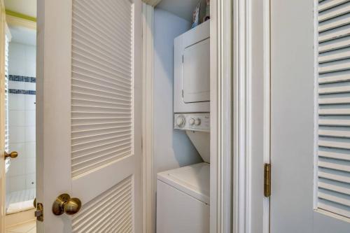 a white laundry room with a washer and dryer at Paradise Place by AvantStay Key West Old Town Condo w Shared Pool in Key West