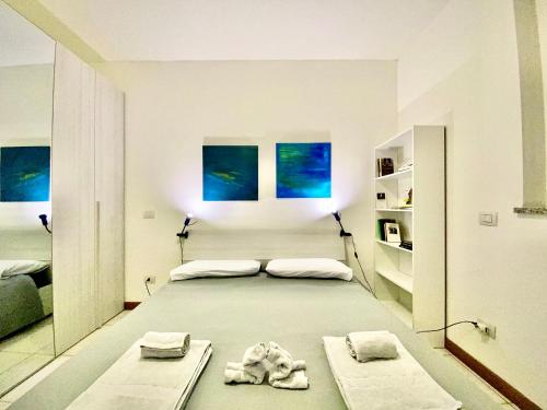 a bedroom with a large bed with towels on it at Triumph Tower Milano Politecnico in Milan