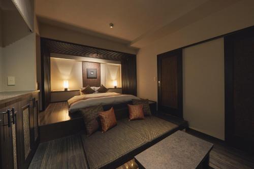 a bedroom with a large bed and a large window at SAKE Kura Hotel 川崎宿 in Kawasaki