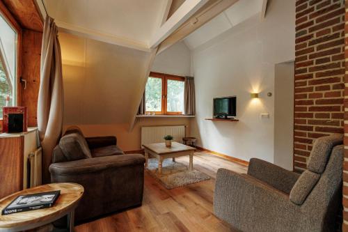 a living room with a couch and a table at 't Eekhoornnest in Soest