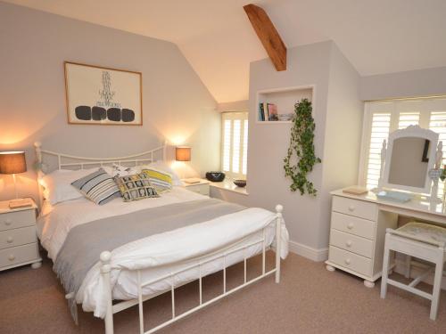 a bedroom with a bed and a dresser and a mirror at 2 bed in Wells 52STT in Wells