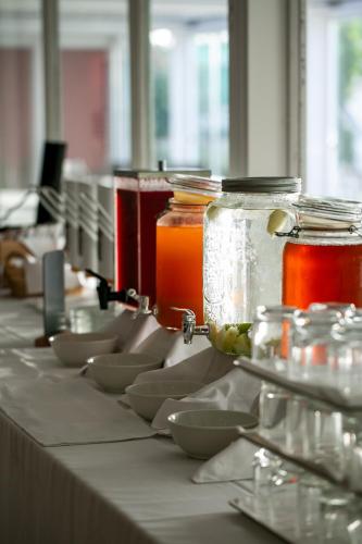 a row of jars and bowls on a table at Living Place Hotel in Villanova