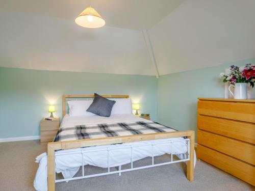 a bedroom with a bed and a dresser in a room at 3 Bed in Brixham BX002 in Brixham