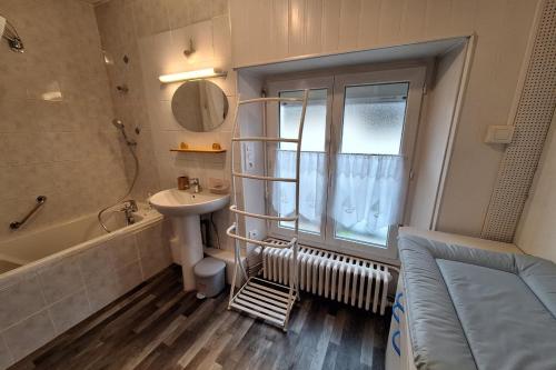 a bathroom with a sink and a bath tub and a sink at Gîte Le Cep de Bouzy in Bouzy