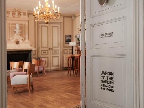a room with a door with a sign on it at Logis Hôtel de l'Europe in Poitiers