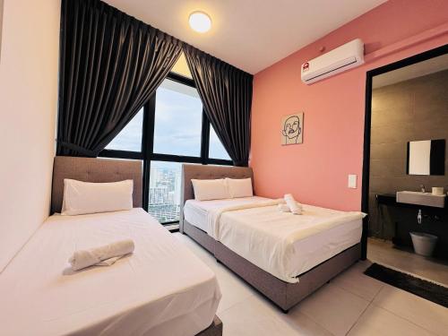 a bedroom with two beds and a large window at New 2BR or 3BR Cozy Urban Suite Homestay at Georgetown8-10pax by URBAN STAYCATIONS LOD in Jelutong