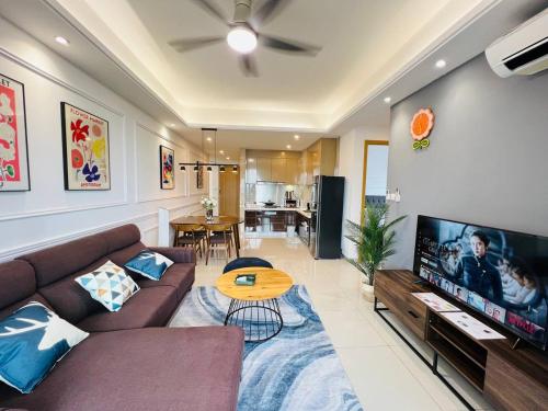 a living room with a couch and a flat screen tv at R&F PRINCESS COVE at ANJU in Johor Bahru