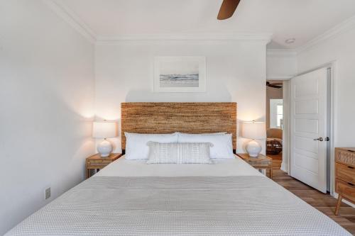 a white bedroom with a large bed with two lamps at Vitamin Sea by AvantStayMinutes from the beach in Destin