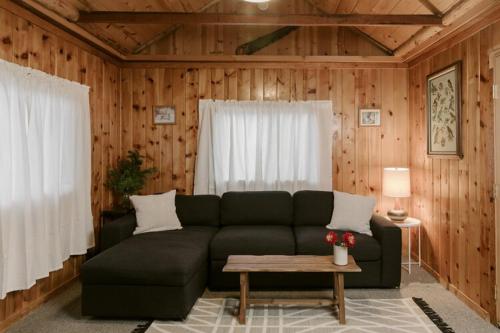 a living room with a green couch and a table at 2403 - Oak Knoll #4 cabin in Big Bear Lake