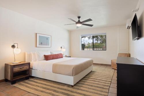 1 dormitorio con 1 cama y ventilador de techo en Starlight Estate by AvantStay 26 People Architectual Mansion w Pool Tennis Court Game Room, en Bermuda Dunes
