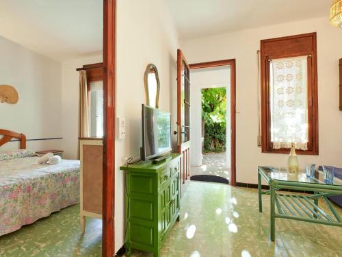 a bedroom with a bed and a television on a dresser at 0328 Apartment in Calella de Palafrugell in Calella de Palafrugell