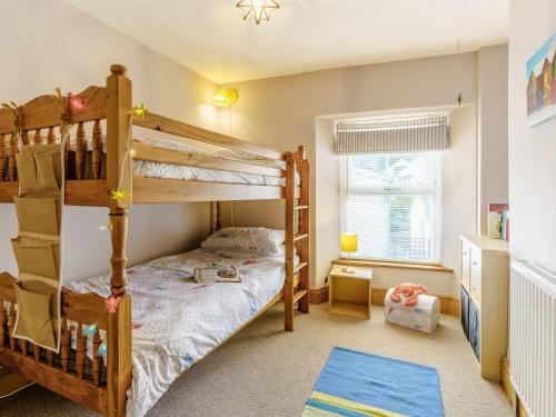 1 dormitorio con 2 literas y ventana en 3 Bed in Cardigan 55196 en Saint Dogmaels