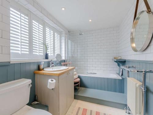 a bathroom with a tub and a sink and a toilet at 3 Bed in Whitstable WCC20 in Whitstable