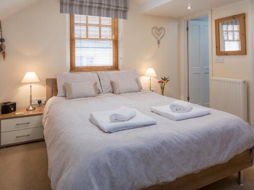 a bedroom with a large bed with two towels on it at 4 bed property in Instow Devon 59699 in Instow