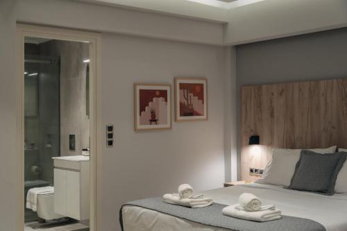 a bedroom with a bed with towels on it at Vialmar Premium Apartments in Rio