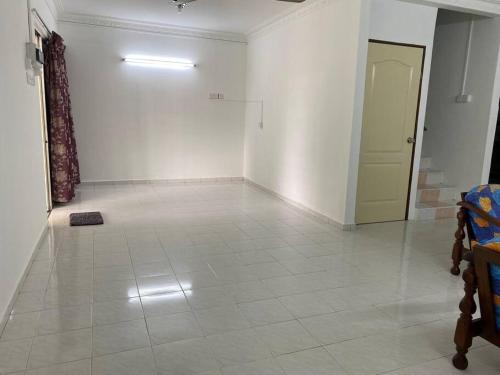 an empty room with a white floor and a door at Go Holiday Taiping Homestay in Simpang