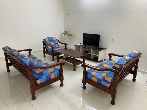 a living room with three chairs and a table at Go Holiday Taiping Homestay in Simpang