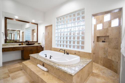 a bathroom with a large tub and a sink at Arcadia by AvantStay Breathtaking Oasis in Scottsdale w Pool Hot Tub Game Room in Scottsdale