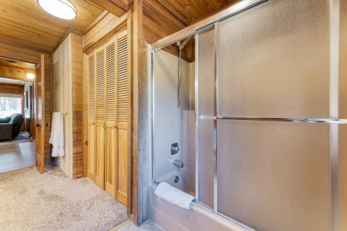 a bathroom with a shower with a glass door at Tennenbaum by AvantStay Classic Cabin in Tahoe Vista - Walk to the Beach in Tahoe Vista
