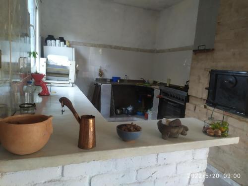 a kitchen with a counter top with a sink and a counter top at Casa de adobe Cuesta blanca in Cordoba