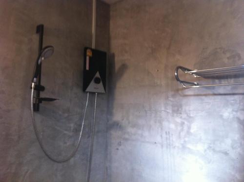 a shower in a bathroom with a phone on the wall at Paradise Hill in Chiang Dao
