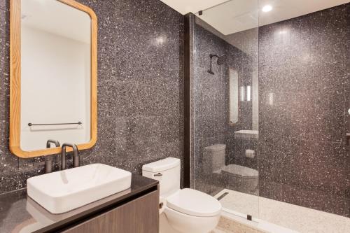 a bathroom with a toilet and a sink and a shower at Vice by AvantStay Brand New Condo Room in Austin w Amazing Amenities in Austin