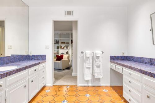 a bathroom with two sinks and blue and white at Dume Point by AvantStay Tennis Pool in Malibu in Malibu