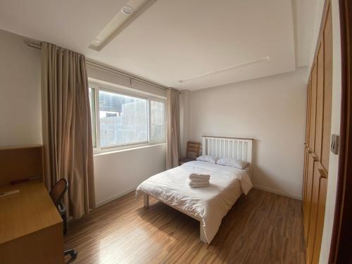 a small bedroom with a bed and a window at Hồ Ba Mẫu Apartment LilyHome in Hanoi