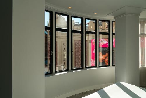 a group of windows in a room with a bed at Vincci Capitol in Madrid