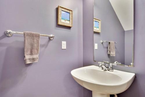 a bathroom with a sink and a mirror at A Little Slice Of Paradise by AvantStay Communal Pool Screened in Porch Great Location Month Long Stays in Stock Island