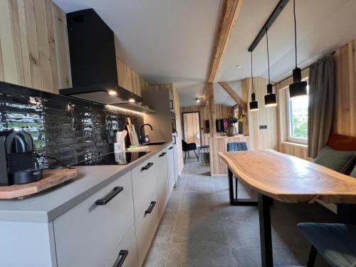 a kitchen with a wooden table and a dining room at Haus Bergquell App 7 in Willingen