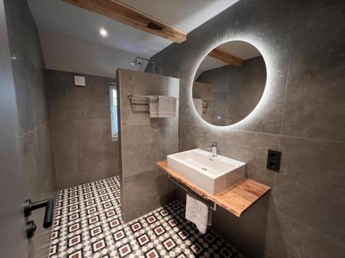 a bathroom with a sink and a mirror at Haus Bergquell App 7 in Willingen
